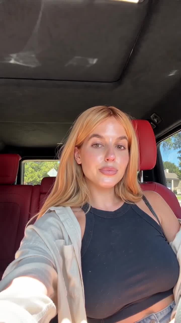 A creator seated in a car, looking toward the camera