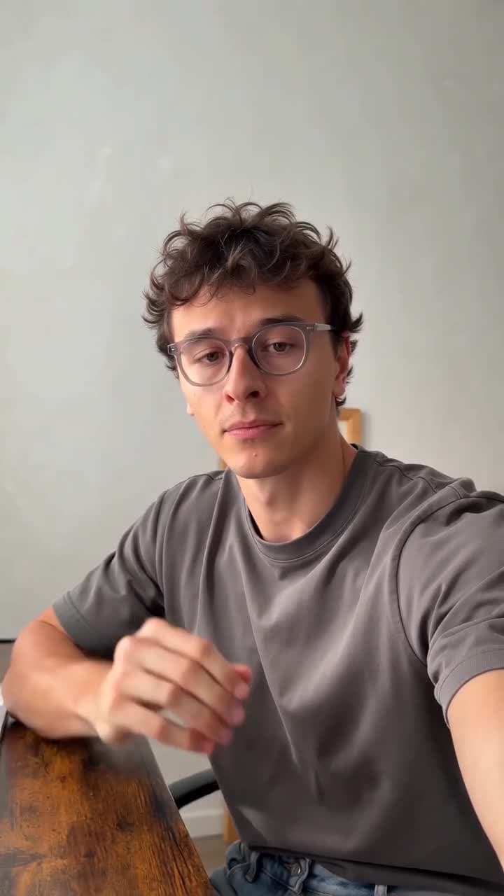 A seated creator using hand gestures indoors